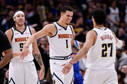 Mar 21, 2024; Denver, Colorado, USA; Denver Nuggets forward Michael Porter Jr. (1) reacts with guard Jamal Murray (27) ahead of forward Aaron Gordon (50) in the fourth quarter against the New York Knicks at Ball Arena. Mandatory Credit: Isaiah J. Downing-USA TODAY Sports