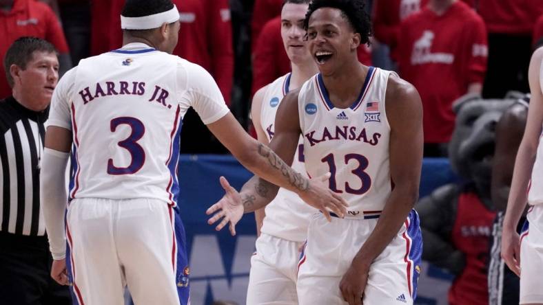 Mar 21, 2024; Salt Lake City, UT, USA; Kansas Jayhawks guard Elmarko Jackson (13) celebrates with guard Dajuan Harris Jr. (3) during the second half in the first round of the 2024 NCAA Tournament against the Samford Bulldogs at Vivint Smart Home Arena-Delta Center. Mandatory Credit: Gabriel Mayberry-USA TODAY Sports