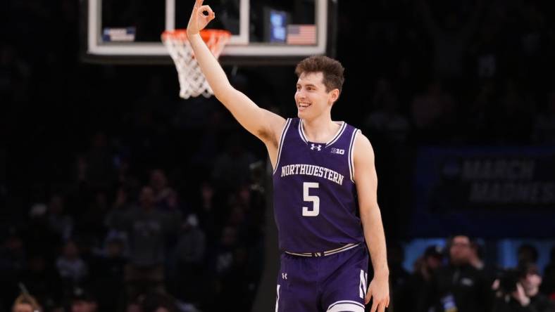 March 22, 2024, Brooklyn, NY, USA;  Northwestern Wildcats guard Ryan Langborg (5) reacts after a three pointer in overtime against the Florida Atlantic Owls in the first round of the 2024 NCAA Tournament at the Barclays Center. Mandatory Credit: Robert Deutsch-USA TODAY Sports