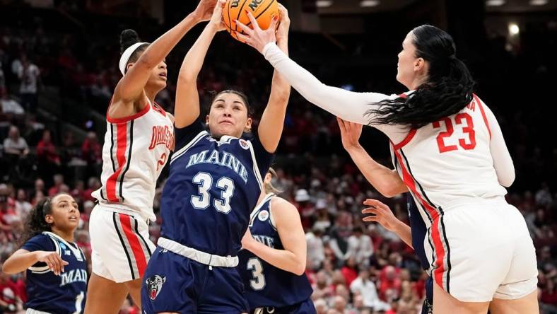 Mar 22, 2024; Columbus, OH, USA; Maine Black Bears forward Adrianna Smith (33) battles for a rebound with Ohio State Buckeyes guard Taylor Thierry (2) and forward Rebeka Mikulasikova (23) during the second half of the women’s basketball NCAA Tournament first round game at Value City Arena. Ohio State won 80-57.