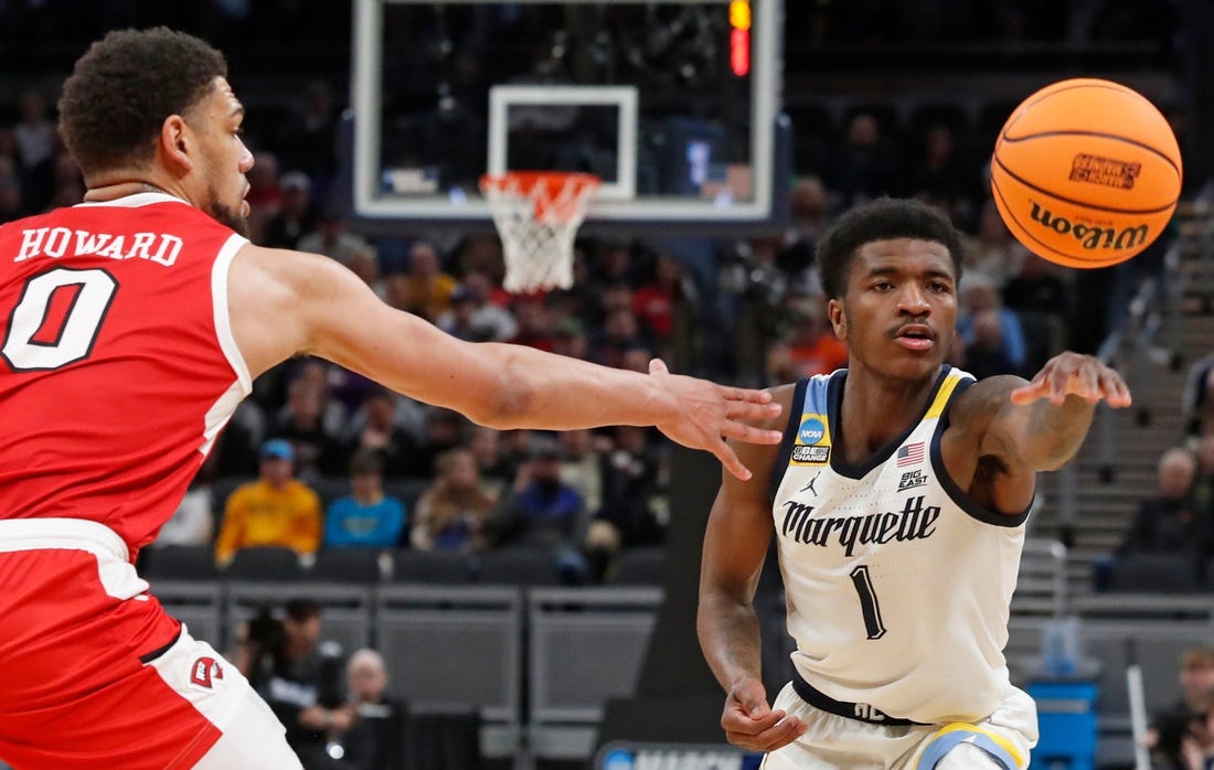 Western Kentucky Hilltoppers forward Rodney Howard (0) defends the pass of Marquette Golden Eagles guard Kam Jones (1) during NCAA Men’s Basketball Tournament game, Friday, March 22, 2024, at Gainbridge Fieldhouse in Indianapolis.