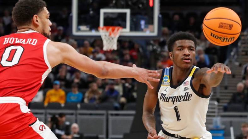 Western Kentucky Hilltoppers forward Rodney Howard (0) defends the pass of Marquette Golden Eagles guard Kam Jones (1) during NCAA Men’s Basketball Tournament game, Friday, March 22, 2024, at Gainbridge Fieldhouse in Indianapolis.