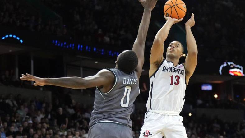 Mar 22, 2024; Spokane, WA, USA; San Diego State Aztecs forward Jaedon LeDee (13) attempts a basket against UAB Blazers forward Javian Davis (0) during the second half in the first round of the 2024 NCAA Tournament at Spokane Veterans Memorial Arena. Mandatory Credit: Kirby Lee-USA TODAY Sports