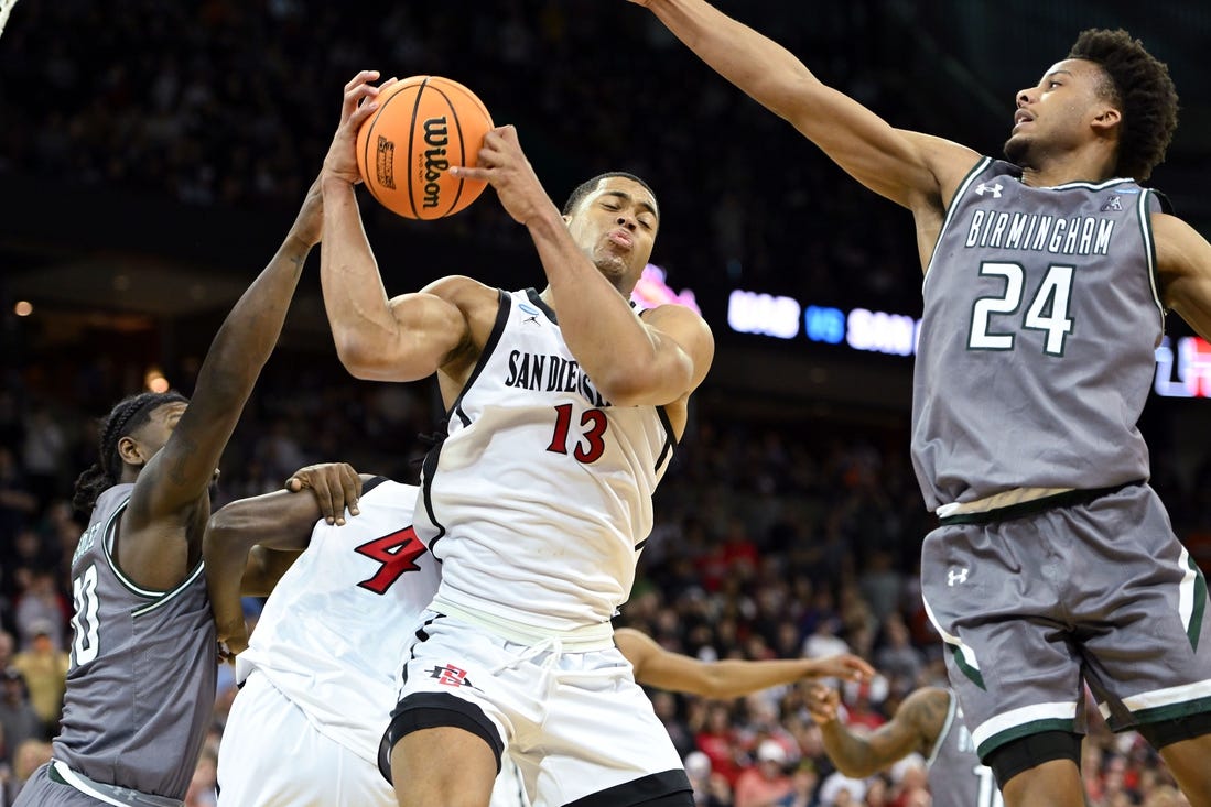 Mar 22, 2024; Spokane, WA, USA; San Diego State Aztecs forward Jaedon LeDee (13) rebounds the ball against UAB Blazers guard Efrem Johnson (24)  during the second half in the first round of the 2024 NCAA Tournament at Spokane Veterans Memorial Arena. Mandatory Credit: James Snook-USA TODAY Sports