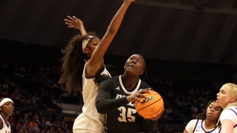 Mar 22, 2024; Baton Rouge, Louisiana, USA; LSU Lady Tigers forward Angel Reese (10) blocks the shot attempt by Rice Owls center Sussy Ngulefac (35) during the first half at Pete Maravich Assembly Center. Mandatory Credit: Stephen Lew-USA TODAY Sports