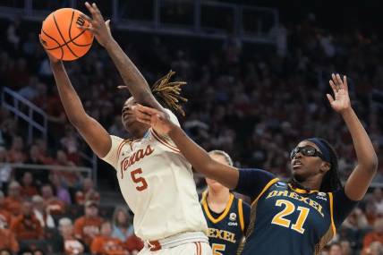 First round: Texas Longhorns forward DeYona Gaston (5) snares a rebound in front of Drexel Dragons forward Jasmine Valentine (21). The Longhorns won 82-42.