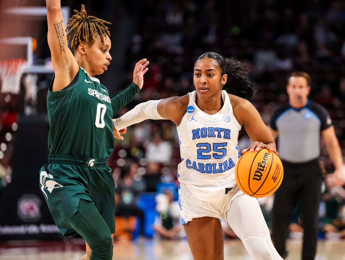 Mar 22, 2024; Columbia, SC, USA; North Carolina Tar Heels guard Deja Kelly (25) drives around Michigan State Spartans guard DeeDee Hagemann (0) in the second half at Colonial Life Arena. Mandatory Credit: Jeff Blake-USA TODAY Sports