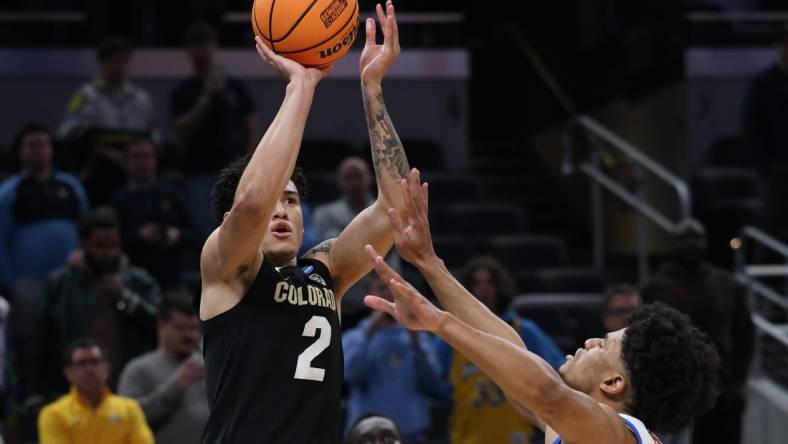 Mar 22, 2024; Indianapolis, IN, USA; Colorado Buffaloes guard KJ Simpson (2) shoots against Florida Gators guard Zyon Pullin (0) in the second half in the first round of the 2024 NCAA Tournament at Gainbridge FieldHouse. Mandatory Credit: Trevor Ruszkowski-USA TODAY Sports