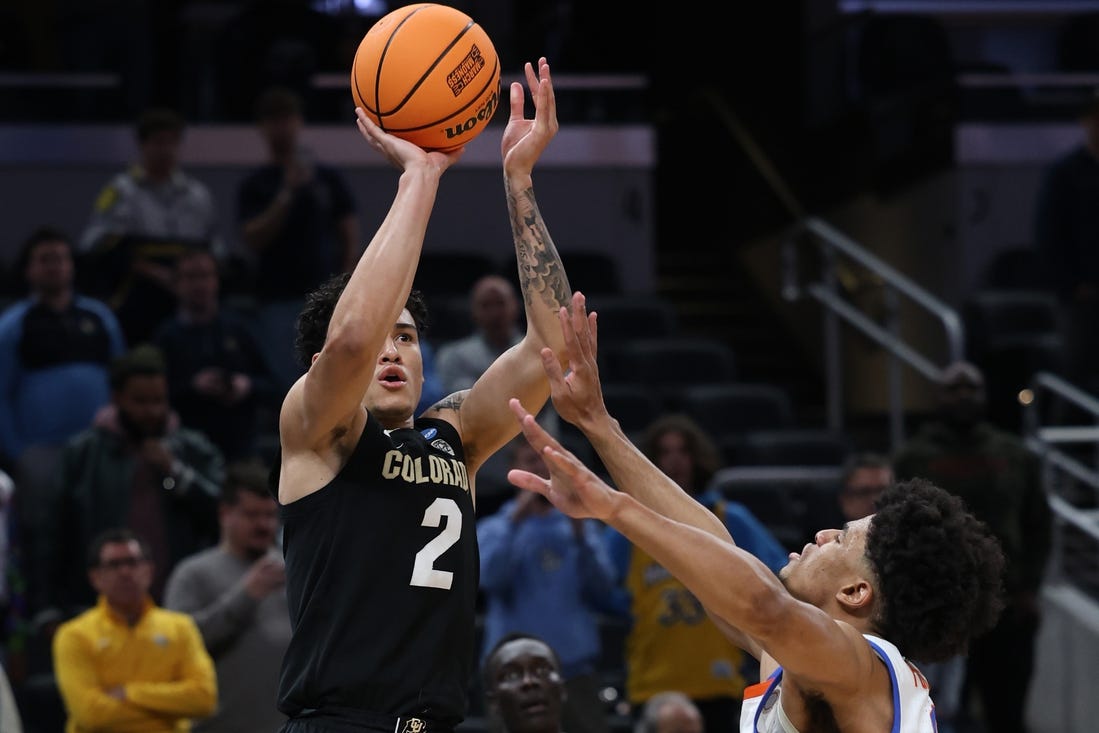 Mar 22, 2024; Indianapolis, IN, USA; Colorado Buffaloes guard KJ Simpson (2) shoots against Florida Gators guard Zyon Pullin (0) in the second half in the first round of the 2024 NCAA Tournament at Gainbridge FieldHouse. Mandatory Credit: Trevor Ruszkowski-USA TODAY Sports
