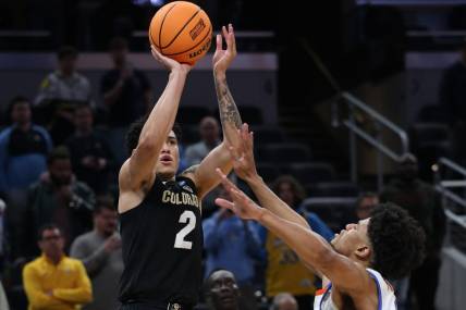 Mar 22, 2024; Indianapolis, IN, USA; Colorado Buffaloes guard KJ Simpson (2) shoots against Florida Gators guard Zyon Pullin (0) in the second half in the first round of the 2024 NCAA Tournament at Gainbridge FieldHouse. Mandatory Credit: Trevor Ruszkowski-USA TODAY Sports