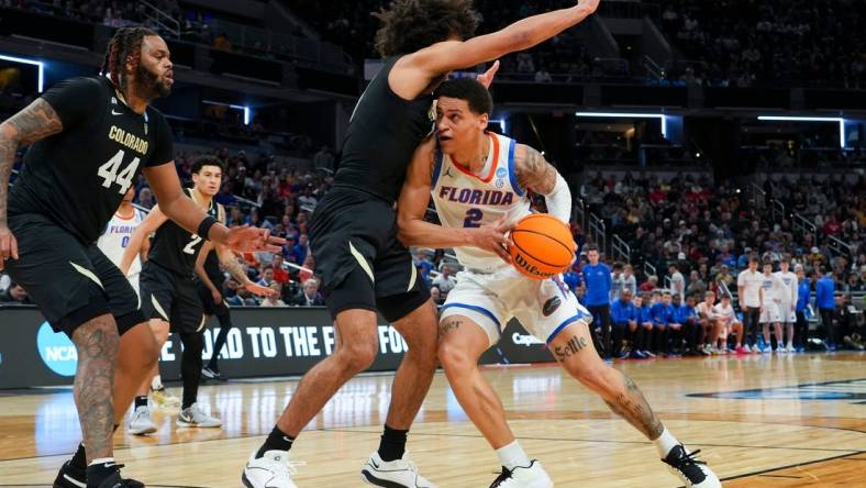 Florida Gators guard Riley Kugel (2) drives the lane against the Colorado Buffaloes on Friday, March 22, 2024, during the first round of the NCAA Men’s Basketball Tournament at Gainbridge Fieldhouse in Indianapolis. Florida Gators and Colorado Buffaloes are tied 45-45 at halftime.