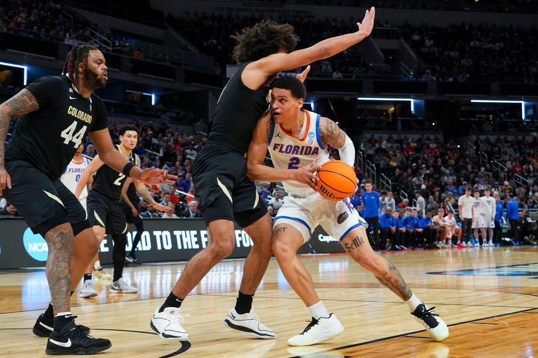 Florida Gators guard Riley Kugel (2) drives the lane against the Colorado Buffaloes on Friday, March 22, 2024, during the first round of the NCAA Men’s Basketball Tournament at Gainbridge Fieldhouse in Indianapolis. Florida Gators and Colorado Buffaloes are tied 45-45 at halftime.