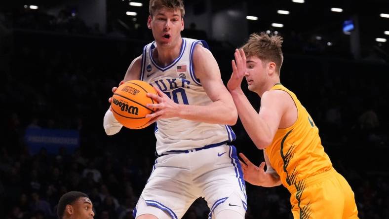 Mar 22, 2024; Brooklyn, NY, USA; Duke Blue Devils center Kyle Filipowski (30) grabs a rebound against the Vermont Catamounts in the first round of the 2024 NCAA Tournament at the Barclays Center. Mandatory Credit: Robert Deutsch-USA TODAY Sports