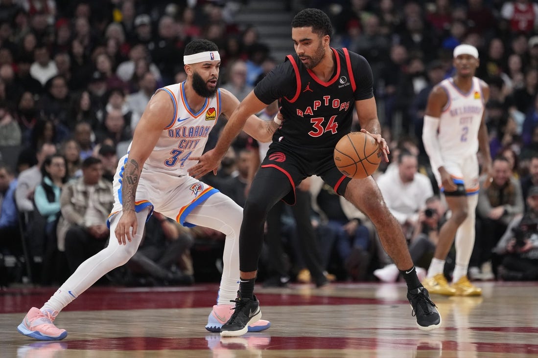 Mar 22, 2024; Toronto, Ontario, CAN; Toronto Raptors forward Jontay Porter (34) controls the ball against Oklahoma City Thunder forward Kenrich Williams (34) during the first half at Scotiabank Arena. Mandatory Credit: John E. Sokolowski-USA TODAY Sports