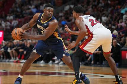 Mar 22, 2024; Miami, Florida, USA;  New Orleans Pelicans forward Zion Williamson (1) brings the ball up the court as Miami Heat forward Haywood Highsmith (24) during the first half at Kaseya Center. Mandatory Credit: Jim Rassol-USA TODAY Sports