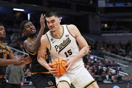 Mar 22, 2024; Indianapolis, IN, USA; Purdue Boilermakers center Zach Edey (15) makes a basket as Grambling State Tigers forward Malik Lamin (32) defends during the second half in the first round of the 2024 NCAA Tournament at Gainbridge FieldHouse. Mandatory Credit: Trevor Ruszkowski-USA TODAY Sports