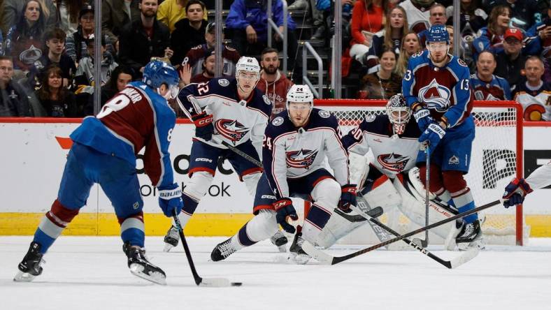 Mar 22, 2024; Denver, Colorado, USA; Colorado Avalanche defenseman Cale Makar (8) controls the puck as Columbus Blue Jackets right wing Mathieu Olivier (24) and defenseman Jake Bean (22) and goaltender Elvis Merzlikins (90) and right wing Valeri Nichushkin (13) look on in the first period at Ball Arena. Mandatory Credit: Isaiah J. Downing-USA TODAY Sports