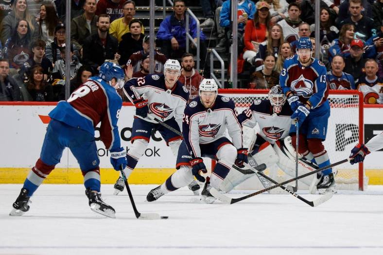Mar 22, 2024; Denver, Colorado, USA; Colorado Avalanche defenseman Cale Makar (8) controls the puck as Columbus Blue Jackets right wing Mathieu Olivier (24) and defenseman Jake Bean (22) and goaltender Elvis Merzlikins (90) and right wing Valeri Nichushkin (13) look on in the first period at Ball Arena. Mandatory Credit: Isaiah J. Downing-USA TODAY Sports