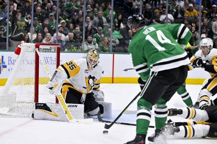 Mar 22, 2024; Dallas, Texas, USA; Dallas Stars left wing Jamie Benn (14) scores a goal against Pittsburgh Penguins goaltender Tristan Jarry (35) during the second period at the American Airlines Center. Mandatory Credit: Jerome Miron-USA TODAY Sports