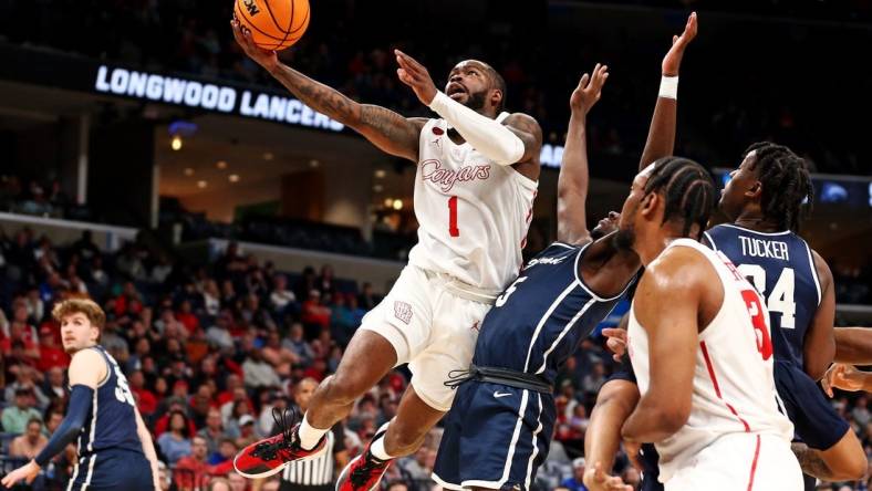 Mar 22, 2024; Memphis, TN, USA;  Houston Cougars guard Jamal Shead (1) shoots the ball against Longwood Lancers guard Johnathan Massie (5) during the first half in the first round of the 2024 NCAA Tournament at FedExForum. Mandatory Credit: Petre Thomas-USA TODAY Sports