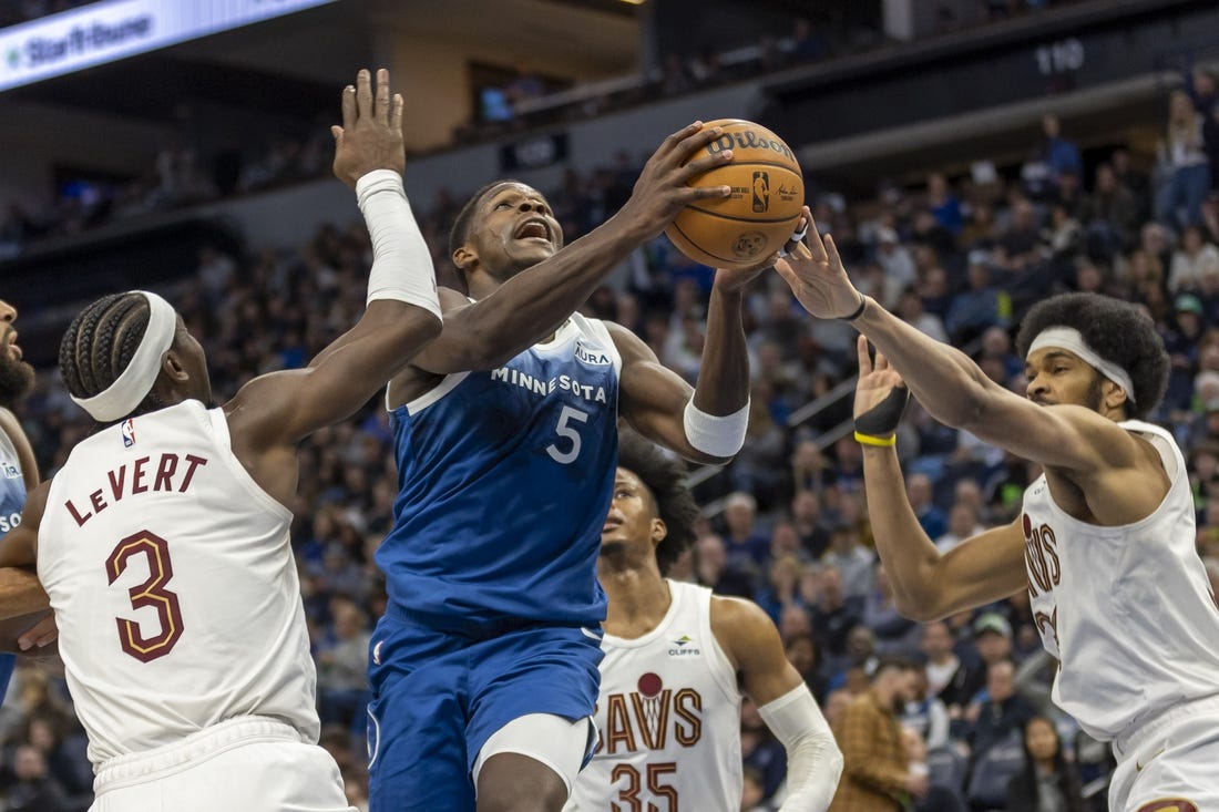 Mar 22, 2024; Minneapolis, Minnesota, USA; Minnesota Timberwolves guard Anthony Edwards (5) drives to the basket past Cleveland Cavaliers center Jarrett Allen (31) and Cleveland Cavaliers guard Caris LeVert (3) in the second half at Target Center. Mandatory Credit: Jesse Johnson-USA TODAY Sports