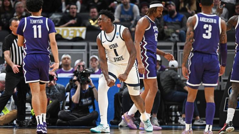 Mar 22, 2024; Indianapolis, IN, USA; Utah State Aggies forward Great Osobor (1) reacts after a play during the first half against the TCU Horned Frogs in the first round of the 2024 NCAA Tournament at Gainbridge FieldHouse. Mandatory Credit: Robert Goddin-USA TODAY Sports