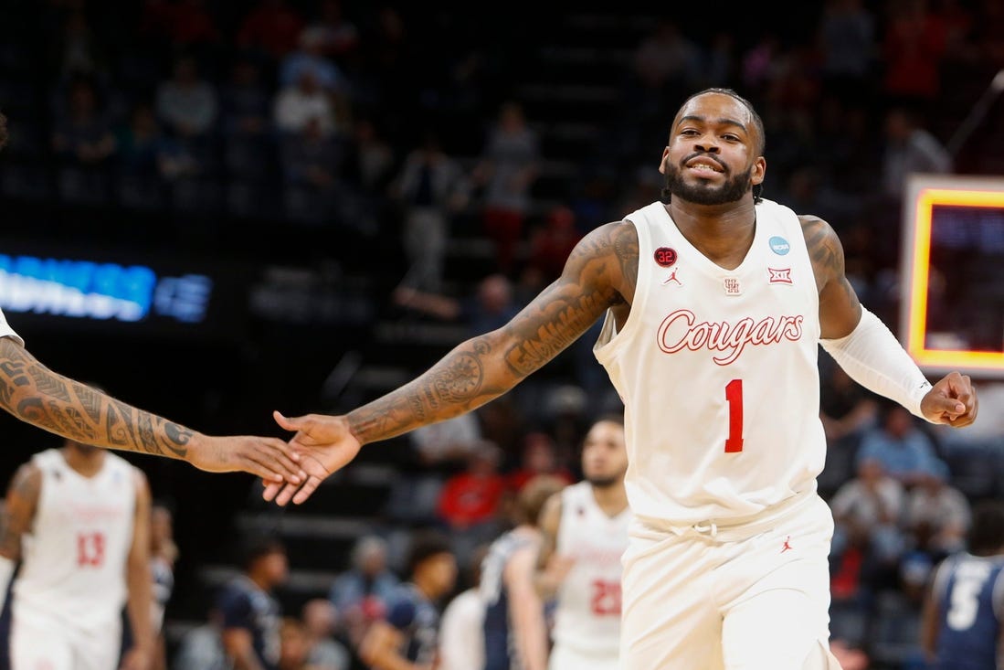 Houston's Jamal Shead (1) high-fives a teammate as he runs off the court while Houston leads at the end of the first half during the first round game between University of Houston and Longwood University in the 2024 NCAA Tournament at FedExForum in Memphis, Tenn., on Friday, March 22, 2024.