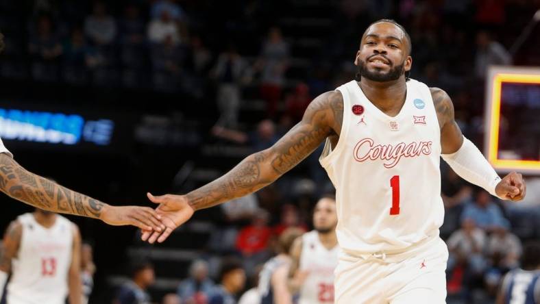 Houston's Jamal Shead (1) high-fives a teammate as he runs off the court while Houston leads at the end of the first half during the first round game between University of Houston and Longwood University in the 2024 NCAA Tournament at FedExForum in Memphis, Tenn., on Friday, March 22, 2024.