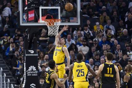 Mar 22, 2024; San Francisco, California, USA; Indiana Pacers guard T.J. McConnell (9) shoots in front of forward Jalen Smith (25) and Golden State Warriors center Trayce Jackson-Davis (32) during the first half at Chase Center. Mandatory Credit: John Hefti-USA TODAY Sports