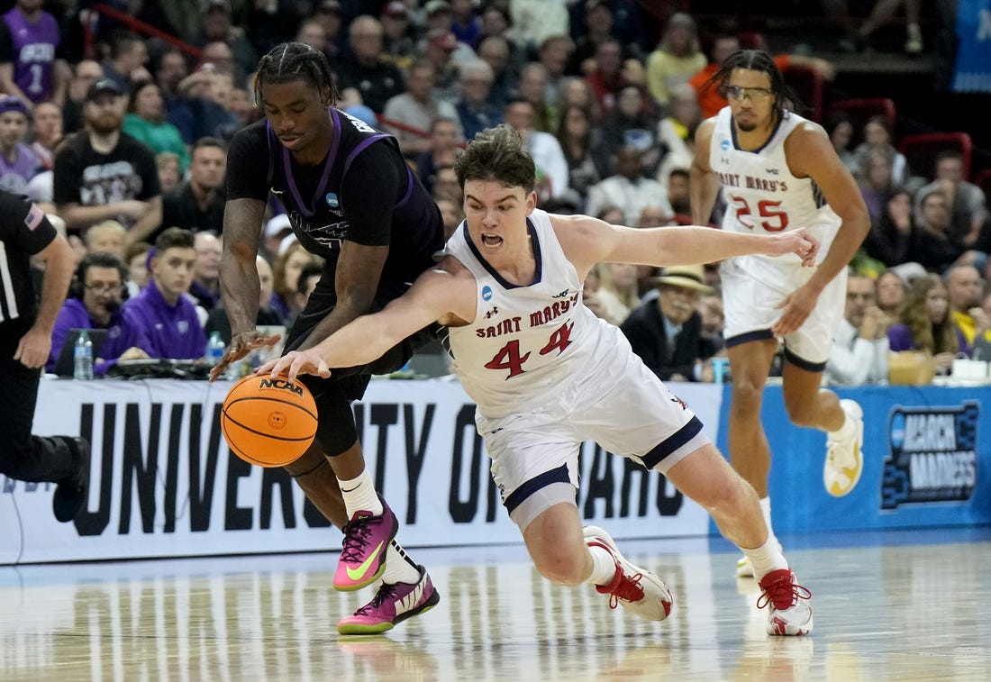 Mar 22, 2024; Spokane, WA, USA; Grand Canyon Antelopes guard Tyon Grant-Foster (7) and St. Mary's Gaels guard Alex Ducas (44) chase a loose ball during the first half in the first round of the 2024 NCAA Tournament at Spokane Veterans Memorial Arena. Mandatory Credit: Kirby Lee-USA TODAY Sports