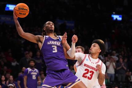 Mar 22, 2024; Brooklyn, NY, USA; James Madison Dukes forward T.J. Bickerstaff (3) shoots the ball over Wisconsin Badgers guard Chucky Hepburn (23) in the first round of the 2024 NCAA Tournament at the Barclays Center.  Mandatory Credit: Robert Deutsch-USA TODAY Sports
