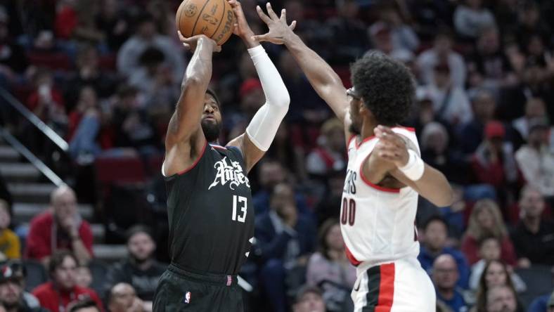 Mar 22, 2024; Portland, Oregon, USA; LA Clippers forward Paul George (13) shoots the ball over Portland Trail Blazers guard Scoot Henderson (00) during the second half at Moda Center. Mandatory Credit: Soobum Im-USA TODAY Sports