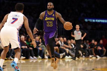 Mar 22, 2024; Los Angeles, California, USA;  Los Angeles Lakers forward LeBron James (23) dribbles the ball against Philadelphia 76ers guard Kyle Lowry (7) during the fourth quarter at Crypto.com Arena. Mandatory Credit: Kiyoshi Mio-USA TODAY Sports