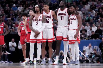 Mar 23, 2024; Salt Lake City, UT, USA; Arizona Wildcats guard Caleb Love (2), forward Keshad Johnson (16), center Oumar Ballo (11) and guard Jaden Bradley (0) watch a technical free throw during the second half in the second round of the 2024 NCAA Tournament against the Dayton Flyers at Vivint Smart Home Arena-Delta Center. Mandatory Credit: Gabriel Mayberry-USA TODAY Sports