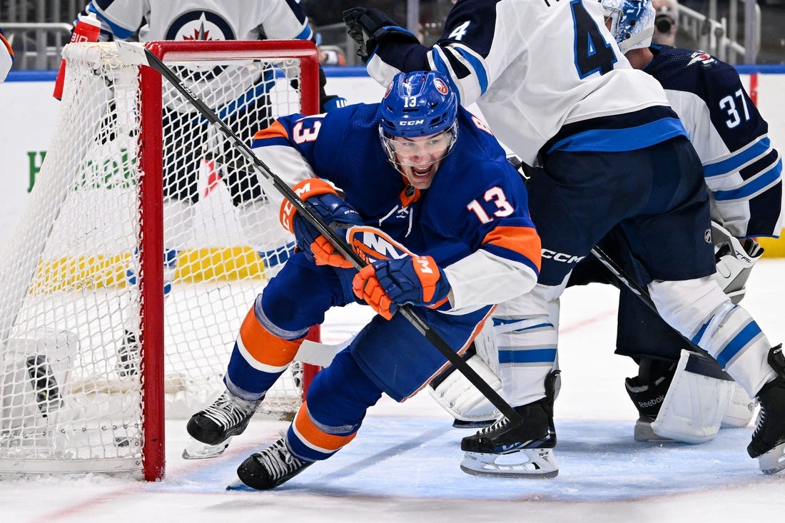 Mar 23, 2024; Elmont, New York, USA;  New York Islanders center Mathew Barzal (13) celebrates his goal against the Winnipeg Jets during the second period at UBS Arena. Mandatory Credit: Dennis Schneidler-USA TODAY Sports
