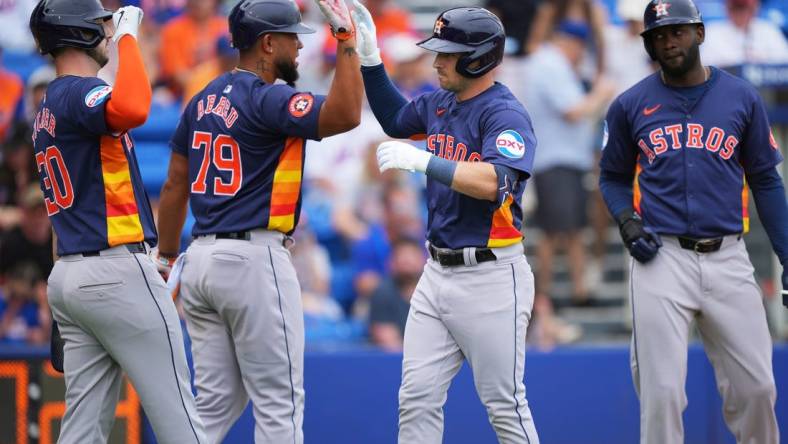 Mar 23, 2024; Port St. Lucie, Florida, USA;  Houston Astros third baseman Alex Bregman, center, is congratulated by first baseman Jose Abreu (79), right fielder Kyle Tucker (30) and designated hitter Yordan Alvarez, right, after hitting a three-run home run in the first inning against the New York Mets at Clover Park. Mandatory Credit: Jim Rassol-USA TODAY Sports