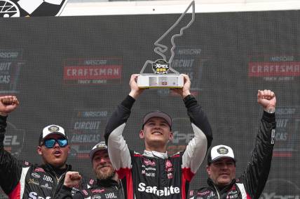 Corey Heim (11) holds up the trophy after wining the NASCAR Craftsman Truck Series Xpel 225 at the Circuit of the Americas on Saturday, March 23, 2024 in Austin.