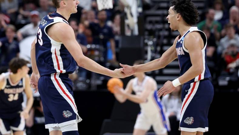 Mar 23, 2024; Salt Lake City, UT, USA; Gonzaga Bulldogs forward Ben Gregg (33) and guard Ryan Nembhard (0) celebrate during the second half in the second round of the 2024 NCAA Tournament against the Kansas Jayhawks at Vivint Smart Home Arena-Delta Center. Mandatory Credit: Rob Gray-USA TODAY Sports