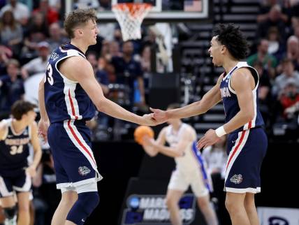 Mar 23, 2024; Salt Lake City, UT, USA; Gonzaga Bulldogs forward Ben Gregg (33) and guard Ryan Nembhard (0) celebrate during the second half in the second round of the 2024 NCAA Tournament against the Kansas Jayhawks at Vivint Smart Home Arena-Delta Center. Mandatory Credit: Rob Gray-USA TODAY Sports