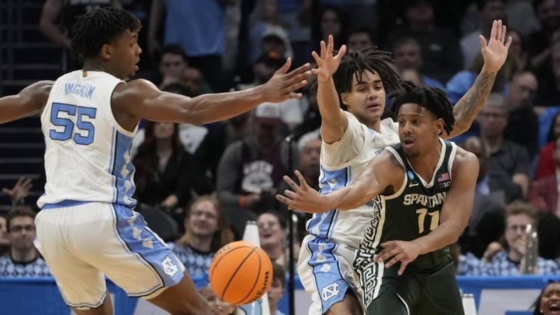 March 23, 2024, Charlotte, NC, USA; Michigan State Spartans guard A.J. Hoggard (11) passes away from North Carolina Tar Heels forward Harrison Ingram (55) and North Carolina Tar Heels guard Elliot Cadeau (2)  in the second round of the 2024 NCAA Tournament at the Spectrum Center. Mandatory Credit: Bob Donnan-USA TODAY Sports