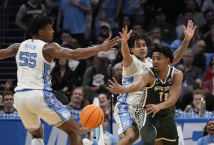 March 23, 2024, Charlotte, NC, USA; Michigan State Spartans guard A.J. Hoggard (11) passes away from North Carolina Tar Heels forward Harrison Ingram (55) and North Carolina Tar Heels guard Elliot Cadeau (2)  in the second round of the 2024 NCAA Tournament at the Spectrum Center. Mandatory Credit: Bob Donnan-USA TODAY Sports