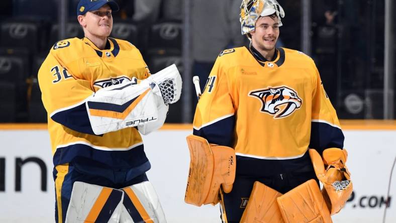 Mar 23, 2024; Nashville, Tennessee, USA; Nashville Predators goaltender Kevin Lankinen (32) and goaltender Juuse Saros (74) skate after a win against the Detroit Red Wings at Bridgestone Arena. Mandatory Credit: Christopher Hanewinckel-USA TODAY Sports