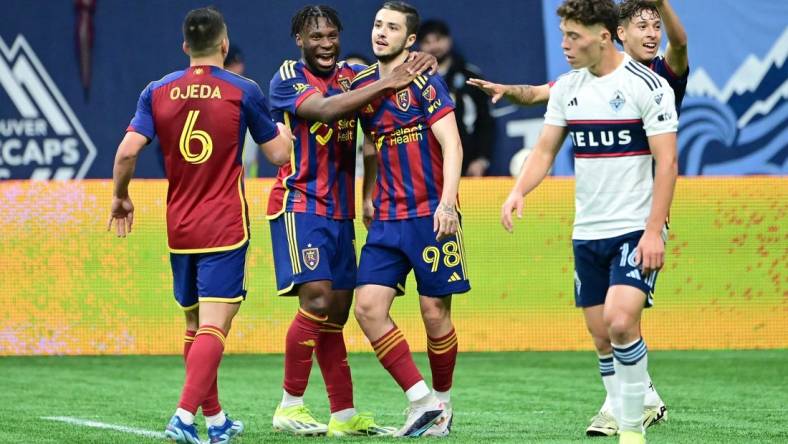 Mar 23, 2024; Vancouver, British Columbia, CAN; Real Salt Lake defender Alexandros Katranis (98) celebrates his second half goal against Vancouver Whitecaps FC with midfielders Emeka Eneli (14) and Braian Ojeda (6) at BC Place. Mandatory Credit: Simon Fearn-USA TODAY Sports