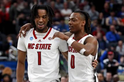 Mar 23, 2024; Pittsburgh, PA, USA; North Carolina State Wolfpack guard Jayden Taylor (1) celebrates with guard DJ Horne (0) after beating the Oakland Golden Grizzlies in the second round of the 2024 NCAA Tournament at PPG Paints Arena. Mandatory Credit: Charles LeClaire-USA TODAY Sports