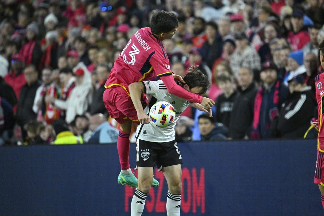 Mar 23, 2024; St. Louis, Missouri, USA; St. Louis CITY SC defender Anthony Markanich (13) challenges D.C. United midfielder Jared Stroud (8) for the ball during the second half at CITYPARK. Mandatory Credit: Scott Rovak-USA TODAY Sports