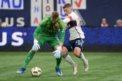 Mar 23, 2024; Vancouver, British Columbia, CAN;  Real Salt Lake goalkeeper Zac MacMath (18) defends against Vancouver Whitecaps FC midfielder Ryan Gauld (25) during the second half at BC Place. Mandatory Credit: Anne-Marie Sorvin-USA TODAY Sports