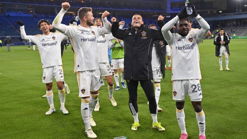 Mar 23, 2024; Kansas City, Kansas, USA; Members of the LA Galaxy celebrate after defeating Sporting Kansas City at Children's Mercy Park. Mandatory Credit: Peter Aiken-USA TODAY Sports