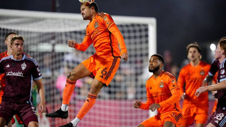 Mar 23, 2024; Commerce City, Colorado, USA; Houston Dynamo FC midfielder Artur (6) heads the ball in front of the Colorado Rapids goal during the first half at Dick's Sporting Goods Park. Mandatory Credit: Ron Chenoy-USA TODAY Sports