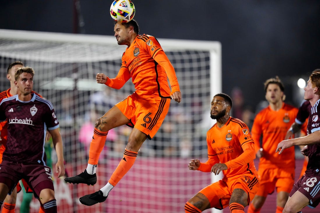 Mar 23, 2024; Commerce City, Colorado, USA; Houston Dynamo FC midfielder Artur (6) heads the ball in front of the Colorado Rapids goal during the first half at Dick's Sporting Goods Park. Mandatory Credit: Ron Chenoy-USA TODAY Sports