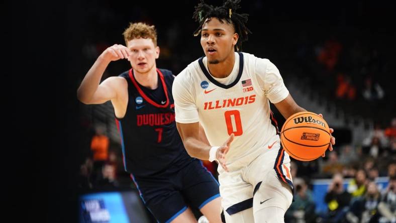 Mar 23, 2024; Omaha, NE, USA; Illinois Fighting Illini guard Terrence Shannon Jr. (0) dribbles the ball against Duquesne Dukes forward Jake Necas (7) during the second half in the second round of the 2024 NCAA Tournament at CHI Health Center Omaha. Mandatory Credit: Dylan Widger-USA TODAY Sports